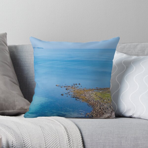Coastlines frame the blue sea Throw Pillow