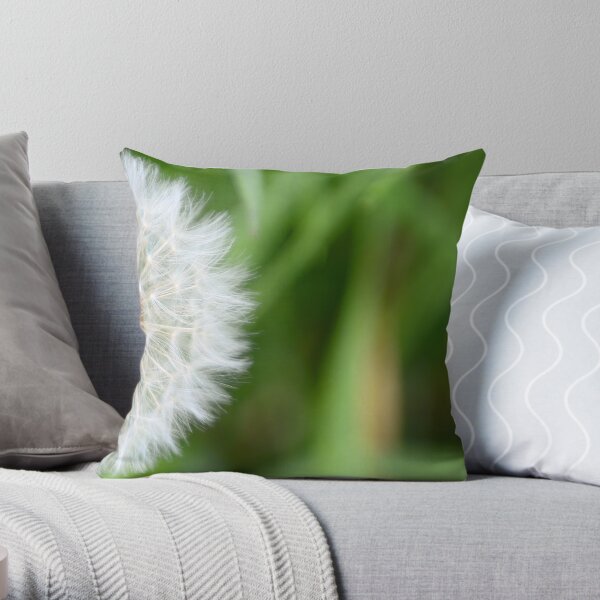 Beautiful full blown white dandelion against a natural green background, to make a wish with Throw Pillow