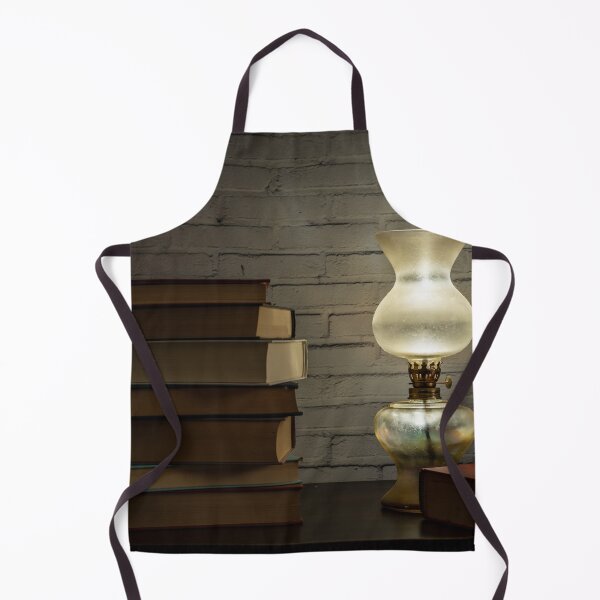Item preview, The light of an oil lamp illuminates books placed on a dark wooden surface designed and sold by brambillasimone.