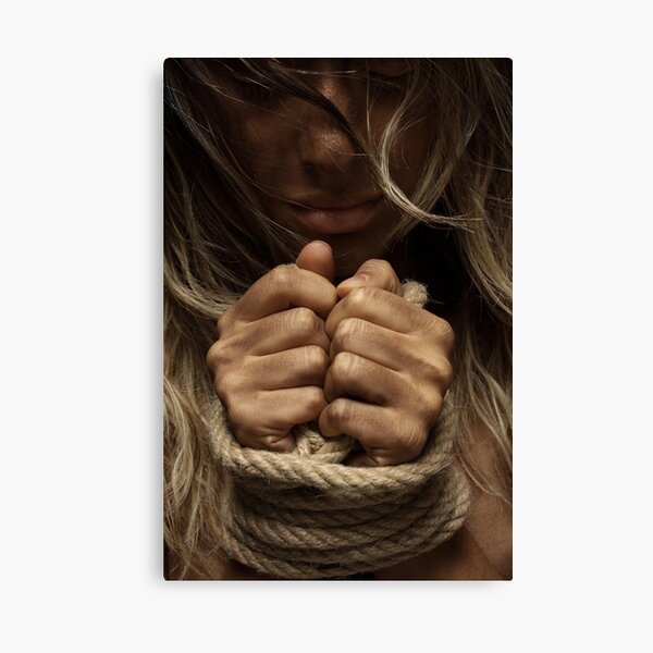 Hands of a girl tied up with a rope Canvas Print