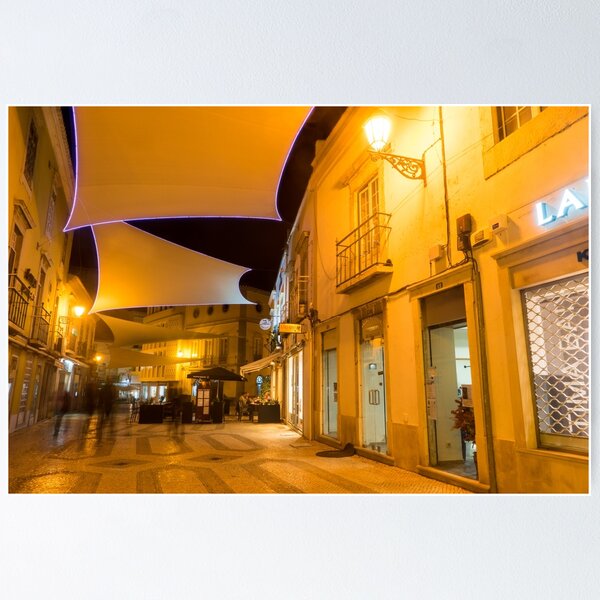 Item preview, Encantador Faro Algarve Portugal - Calle comercial nocturna con toldos de lona frescos designed and sold by Georgia Mizuleva.