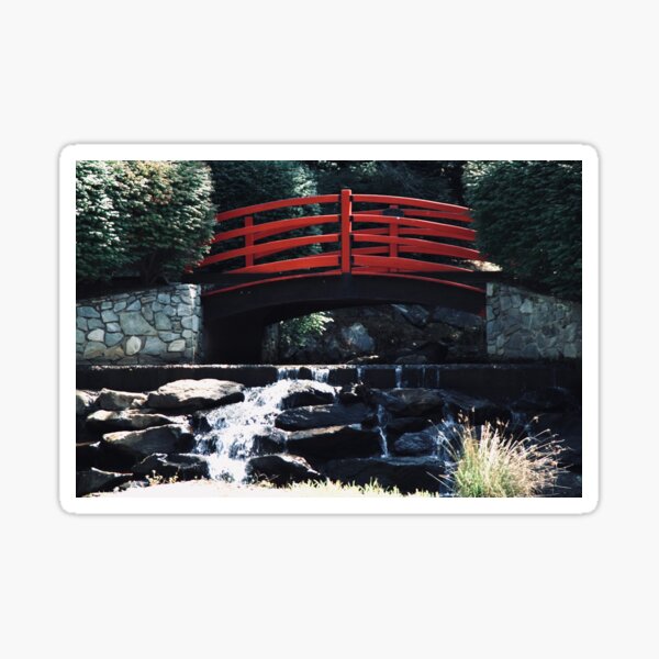 Red bridge with running water under it. Sticker