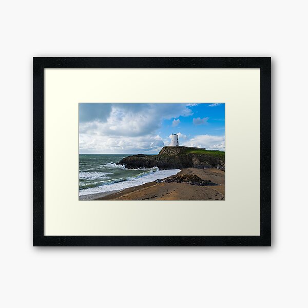Lighthouse by the beach Framed Art Print