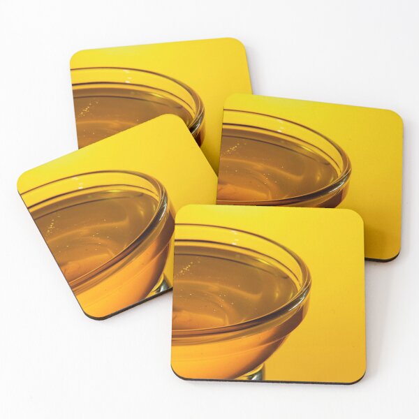 Item preview, Close-up side view of a small glass bowl of honey on a yellow background with backlight designed and sold by vladromensky.