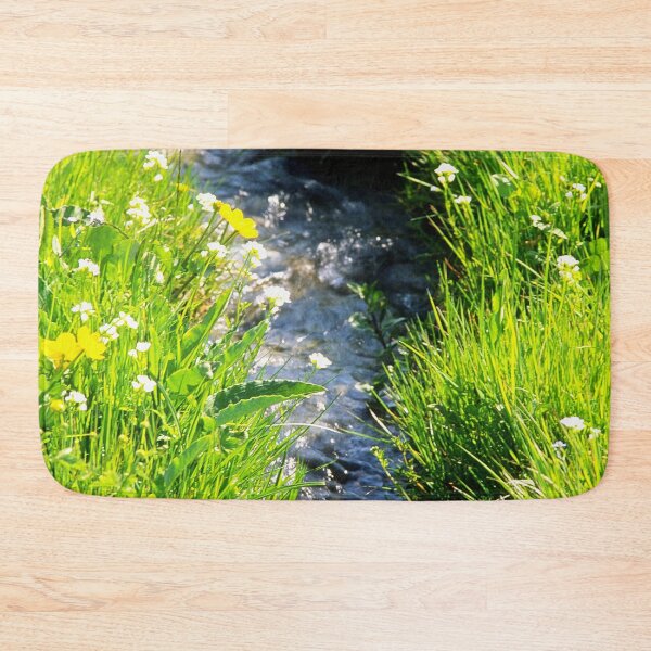 Item preview, Gently babbling brook meandering through a bright green field with summer wild flowers. Close up. designed and sold by JellyBeenzz.