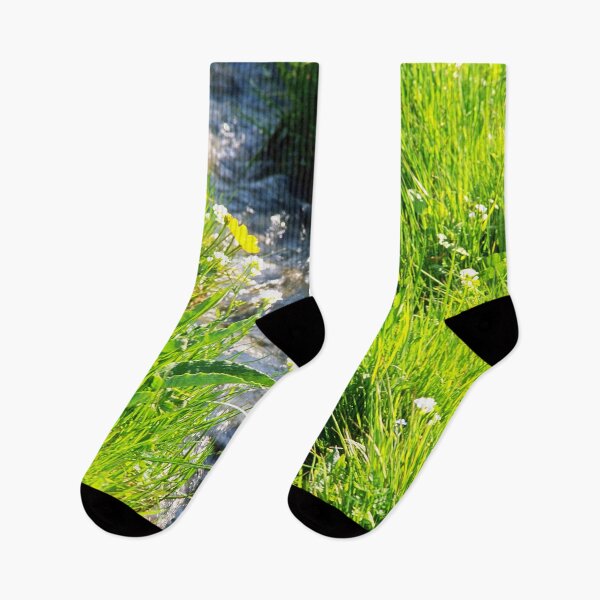Item preview, Gently babbling brook meandering through a bright green field with summer wild flowers. Close up. designed and sold by JellyBeenzz.