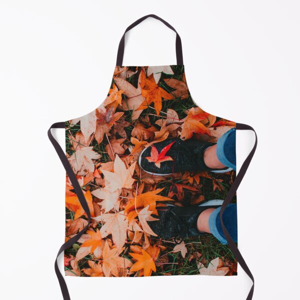 Item preview, Vertical shot of a pair of cute feet covered by orange autumn leaves designed and sold by Carmen Jost.