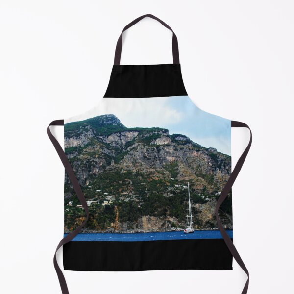 Item preview, View in Amalfi coast at a huge mountain with rocky parts, greenery and buildings with a white boat underneath designed and sold by Kristina Drozd.
