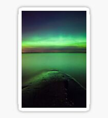 Northern lights glow over lake Sticker