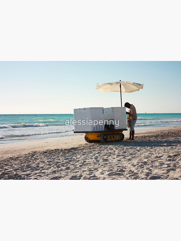 "anonymous summer ice cream man with his cart on the sandy beach rests
