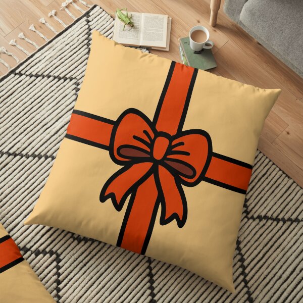 Festive Red Gift Bow on Gold Floor Pillow