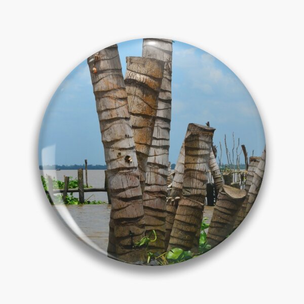 Item preview, Tree trunks used as a break-wall in a muddy river. designed and sold by EAnneH.