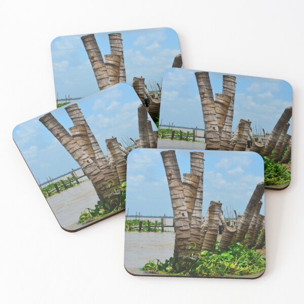 Item preview, Tree trunks used as a break-wall in a muddy river. designed and sold by EAnneH.