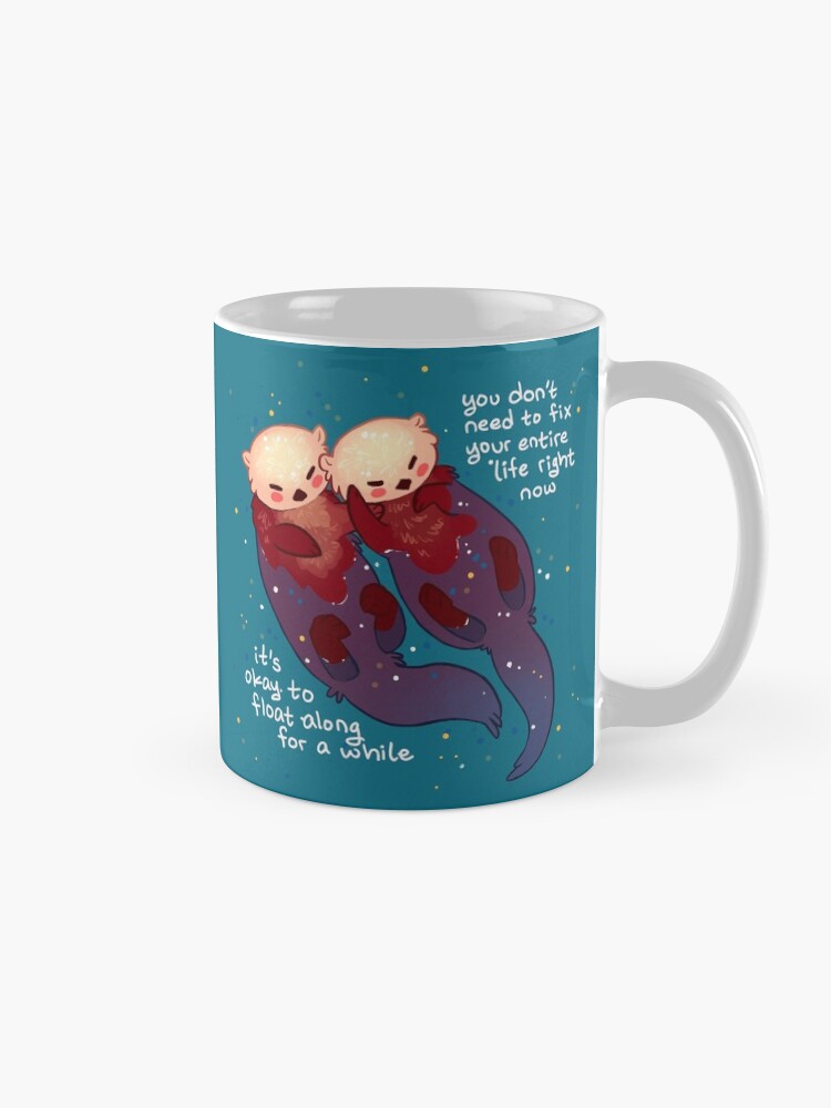 Alternate view of "It's Okay to Float Along For a While" Hand Holding Otters Coffee Mug
