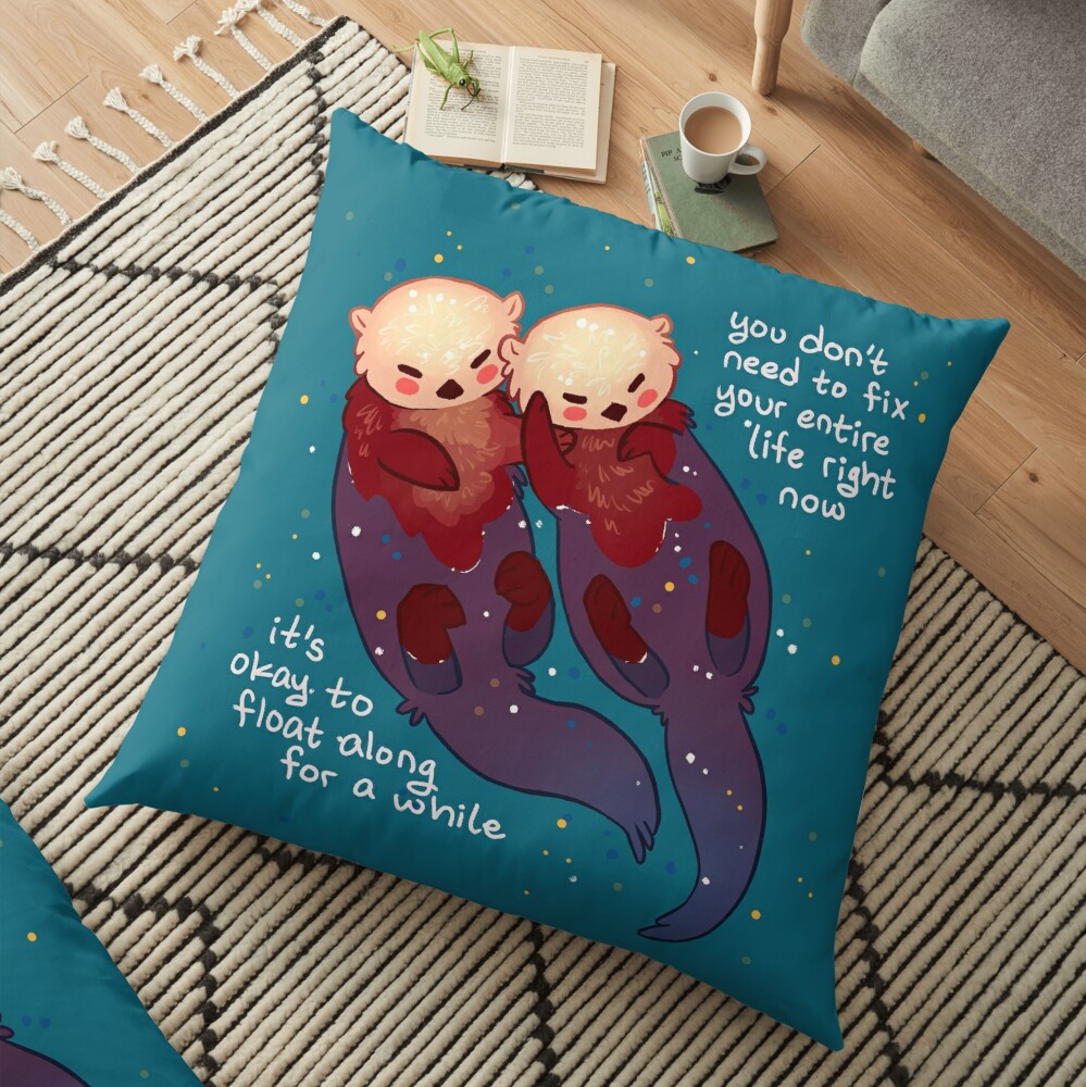 "It's Okay to Float Along For a While" Hand Holding Otters Floor Pillow