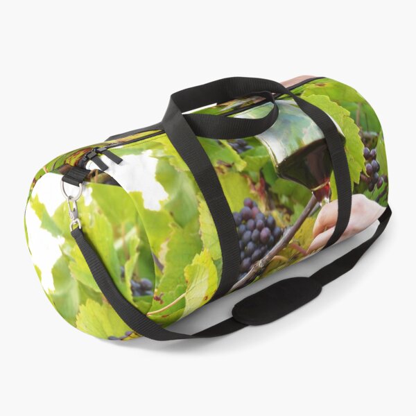 Item preview, Glass of red wine in the vineyard designed and sold by wineandwords.