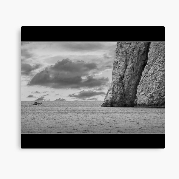 Boat in Kamari Beach Ocean in Santorini Greece Canvas Print