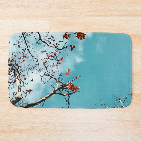 Item preview, Tree branch with orange autumn leaves and blue sky background designed and sold by Mrvell.
