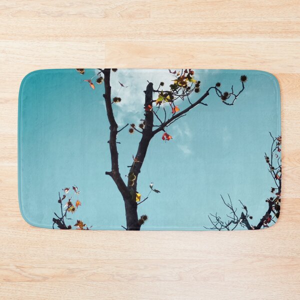 Item preview, Tree branch and orange autumn leaves with blue sky background designed and sold by Mrvell.