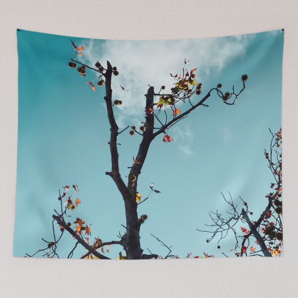 Item preview, Tree branch and orange autumn leaves with blue sky background designed and sold by Mrvell.
