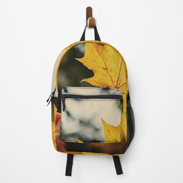 Item preview, Hand holding golden yellow maple leaf designed and sold by lena-maximova.