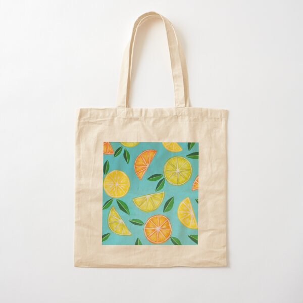 Fresh citrus in mesh bag on beige background. Lemons and limes in