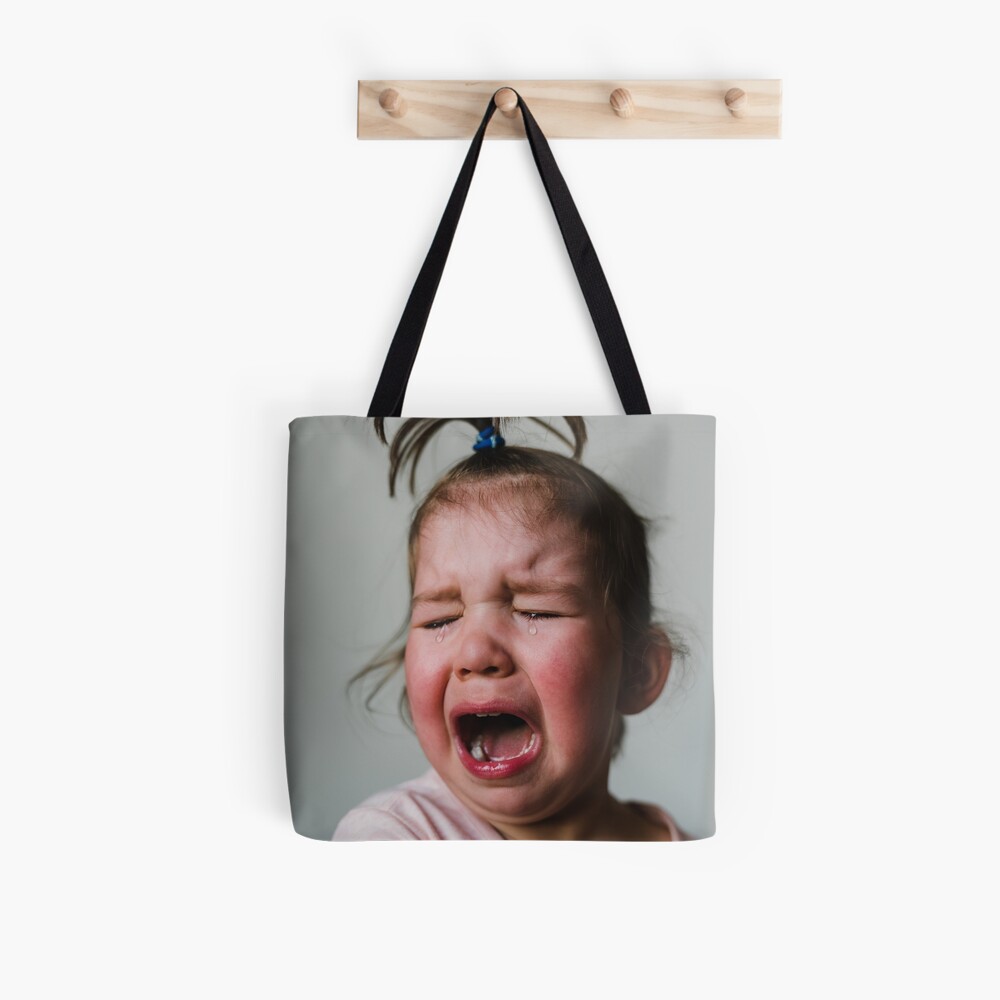 Crying Toddler Girl with Funny Topknot