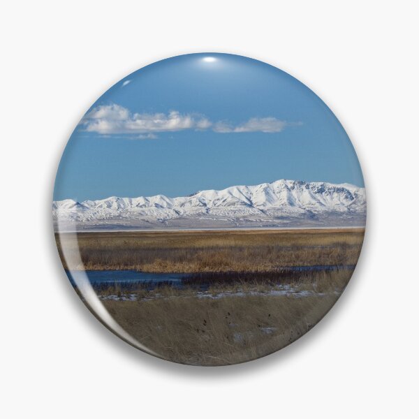 Item preview, Mountain range with snow and blue water, clouds, sky and brown grass designed and sold by Ventures1.