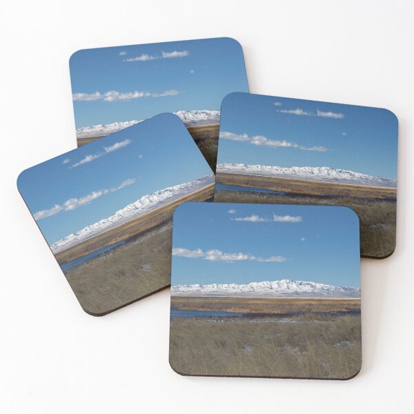 Item preview, Mountain range with snow and blue water, clouds, sky and brown grass designed and sold by Ventures1.