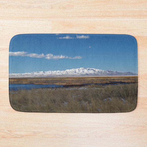 Item preview, Mountain range with snow and blue water, clouds, sky and brown grass designed and sold by Ventures1.