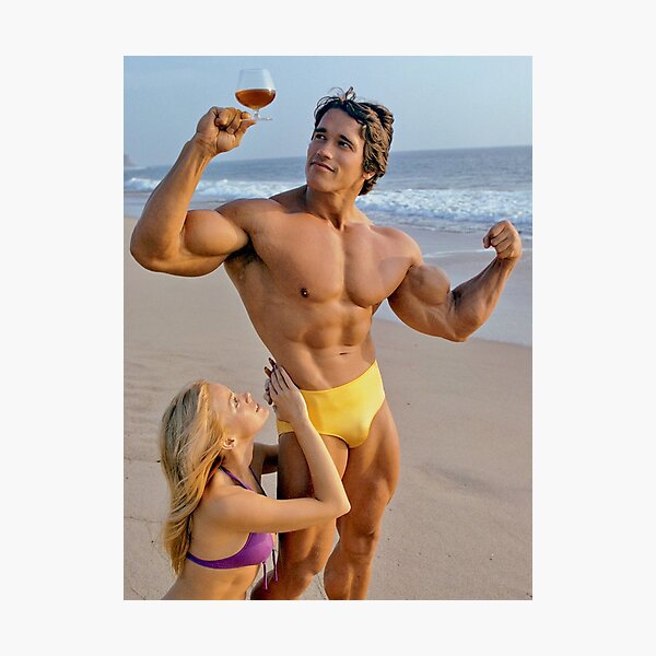 Arnold Schwarzenegger posing with lady on the beach in the 70s Photographic Print