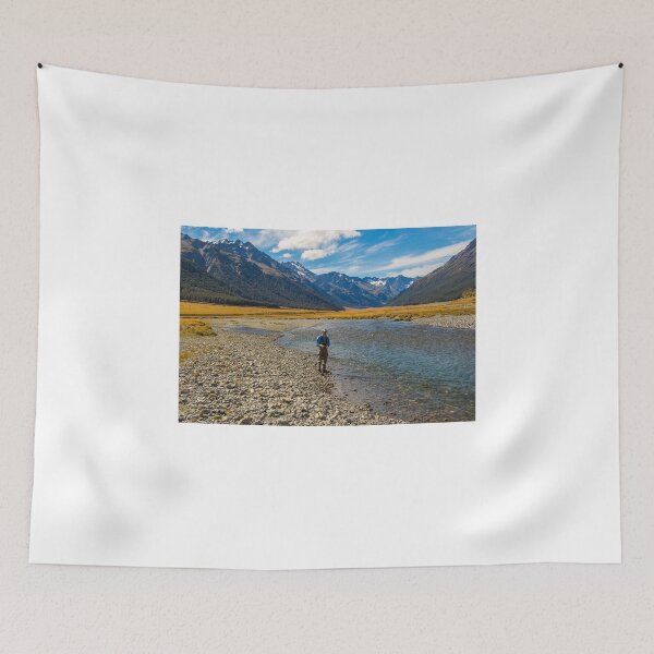 Item preview, An Angler fly fishing for trout on the Ahuriri river, surrounded by mountains designed and sold by SnapTPhotograph.