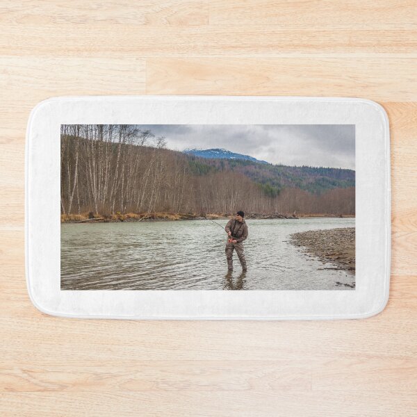 Item preview, A fly fisherman hooked into a big fish in a river with the rod bent designed and sold by SnapTPhotograph.