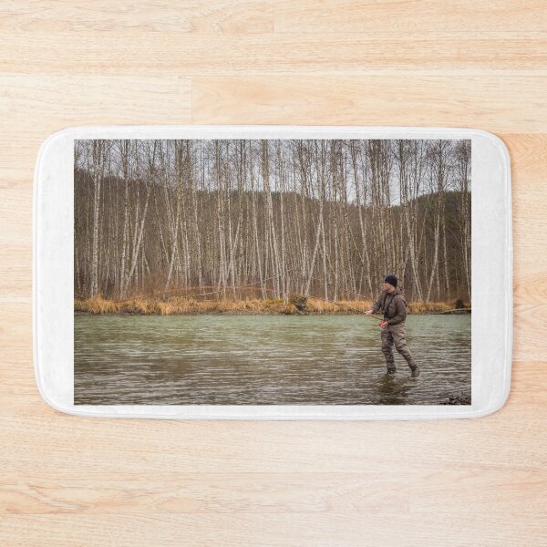 Item preview, A fly fisherman hooked into a big fish in a river with the rod bent designed and sold by SnapTPhotograph.