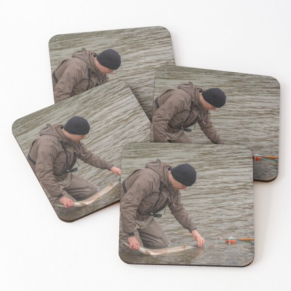 Item preview,  An angler unhooking a fly from a steelhead in the morning spring sun  designed and sold by SnapTPhotograph.