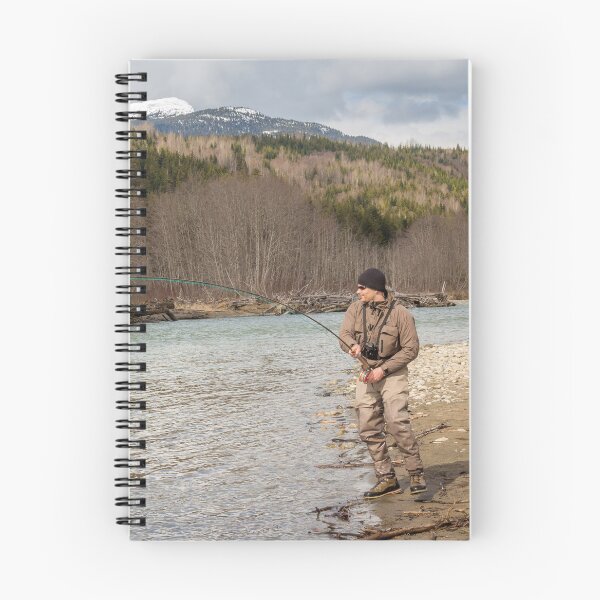 Item preview, A fly fisherman hooked into a big fish in a river with the rod bent designed and sold by SnapTPhotograph.