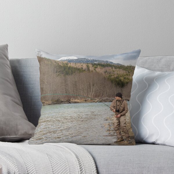 Item preview, A fly fisherman hooked into a big fish in a river with the rod bent designed and sold by SnapTPhotograph.