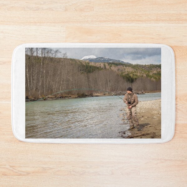 Item preview, A fly fisherman hooked into a big fish in a river with the rod bent designed and sold by SnapTPhotograph.