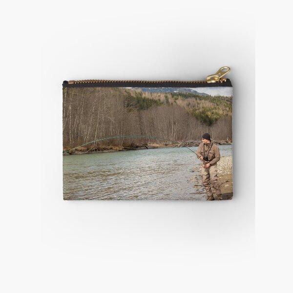 Item preview, A fly fisherman hooked into a big fish in a river with the rod bent designed and sold by SnapTPhotograph.