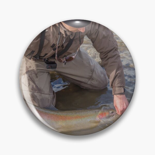 Item preview, An angler unhooking a fly from a steelhead in the morning spring sun designed and sold by SnapTPhotograph.