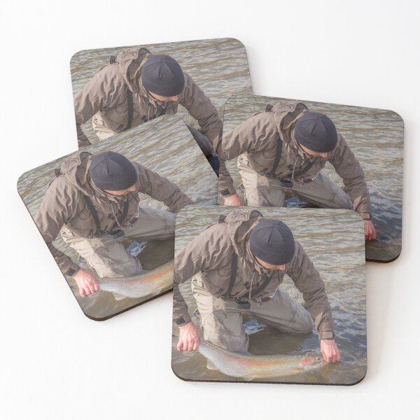 Item preview, An angler unhooking a fly from a steelhead in the morning spring sun designed and sold by SnapTPhotograph.