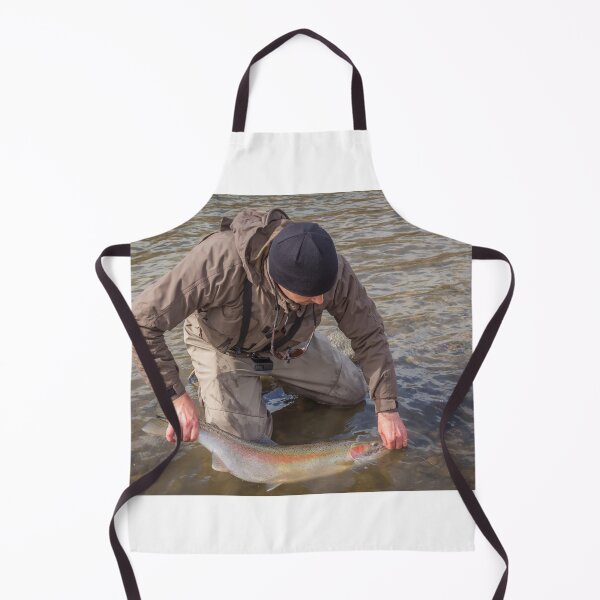 Item preview, An angler unhooking a fly from a steelhead in the morning spring sun designed and sold by SnapTPhotograph.