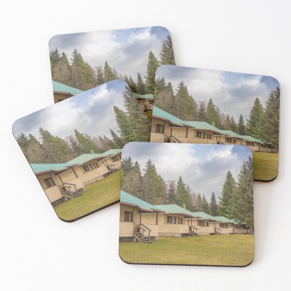 Item preview, A row of cabins set in woodland with dark clouds above designed and sold by SnapTPhotograph.
