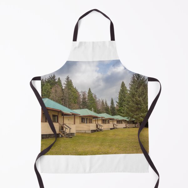 Item preview, A row of cabins set in woodland with dark clouds above designed and sold by SnapTPhotograph.