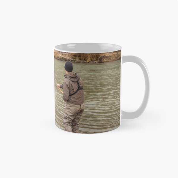 Item preview, A fly fisherman hooked into a big fish in a river with the rod bent designed and sold by SnapTPhotograph.