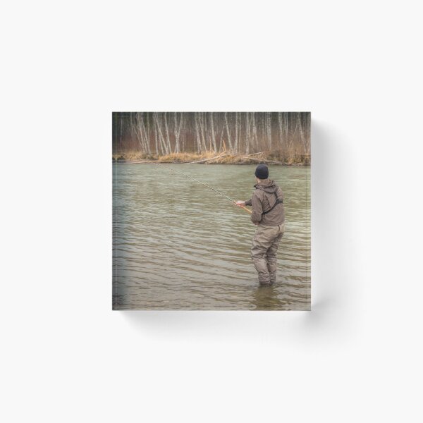 Item preview, A fly fisherman hooked into a big fish in a river with the rod bent designed and sold by SnapTPhotograph.