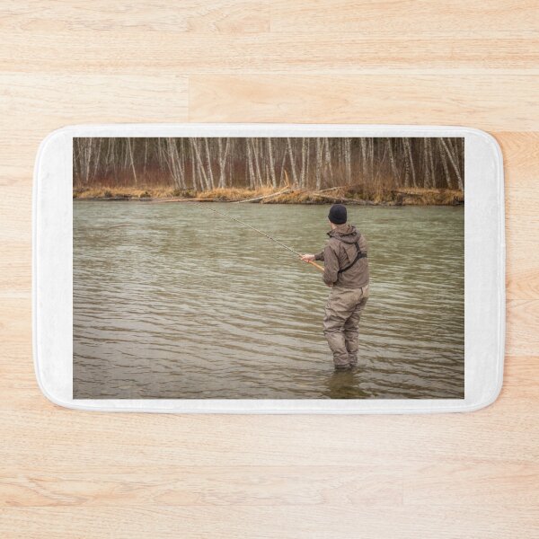 Item preview, A fly fisherman hooked into a big fish in a river with the rod bent designed and sold by SnapTPhotograph.