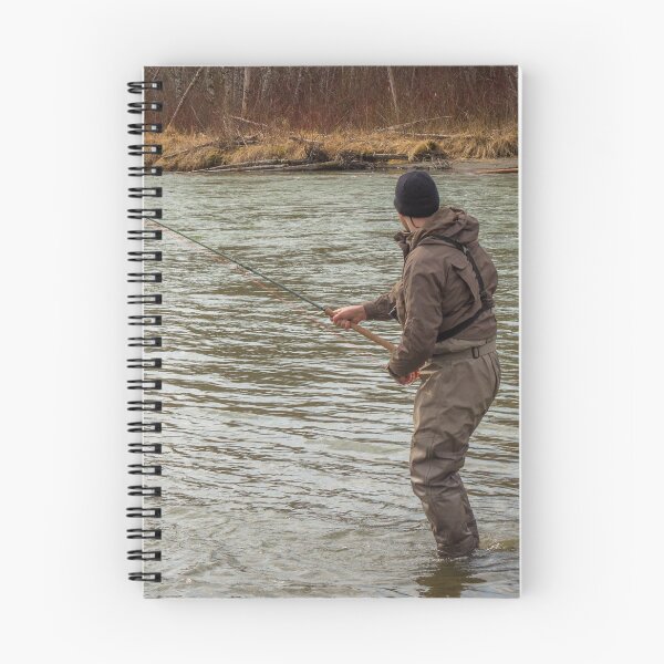 Item preview, A fly fisherman hooked into a big fish in a river with the rod bent designed and sold by SnapTPhotograph.