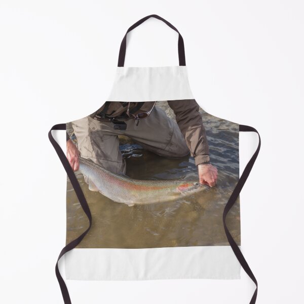 Item preview, An angler unhooking a fly from a steelhead in the morning spring sun designed and sold by SnapTPhotograph.