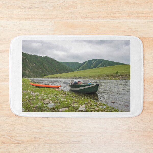 Item preview, A fishing raft and kayak anchored on grass bank beside the river designed and sold by SnapTPhotograph.